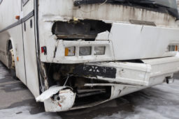a bus with a smashed front-end